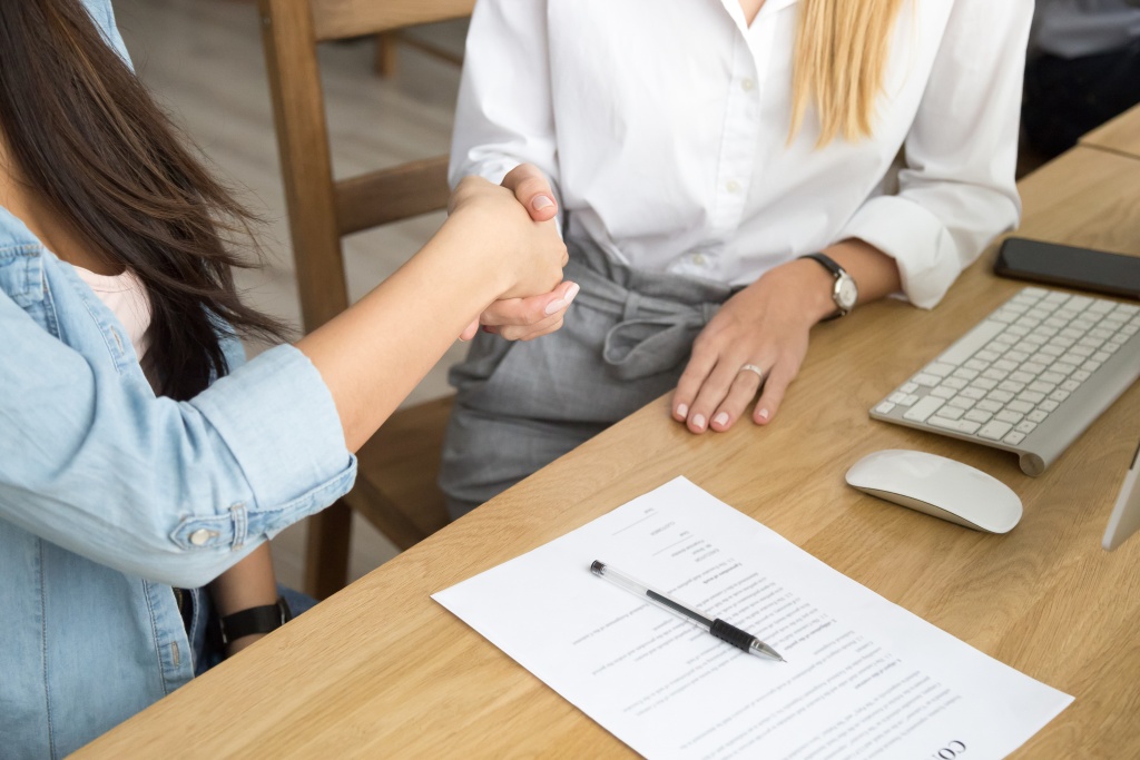 two-women-partners-handshaking-after-signing-business-contract-meeting.jpg